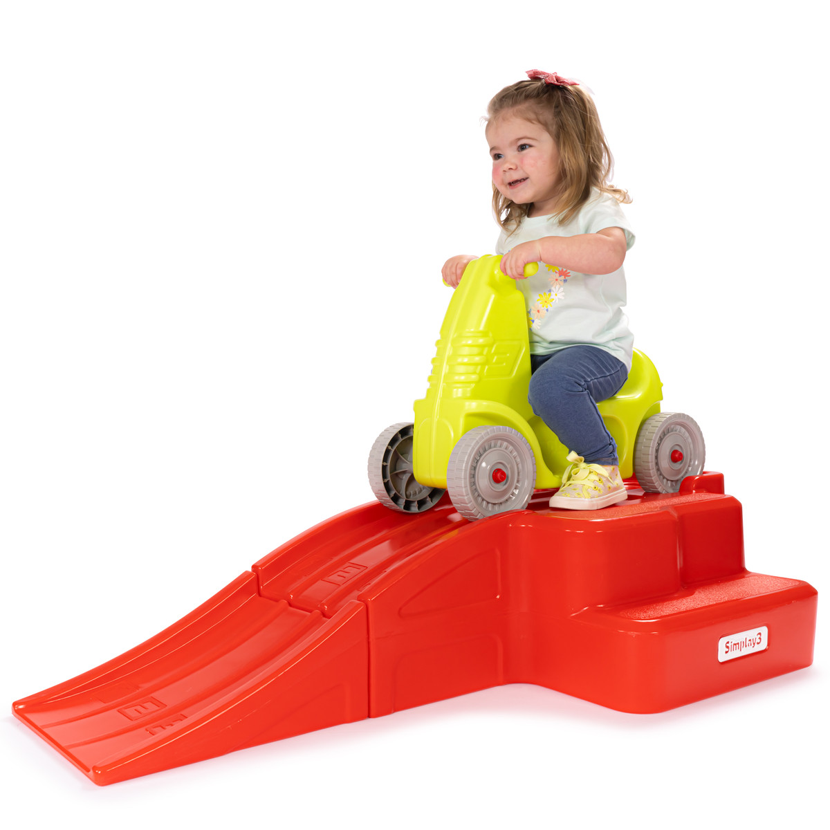 Child seated in ride on car ready to coast down at home roller coaster ramp
