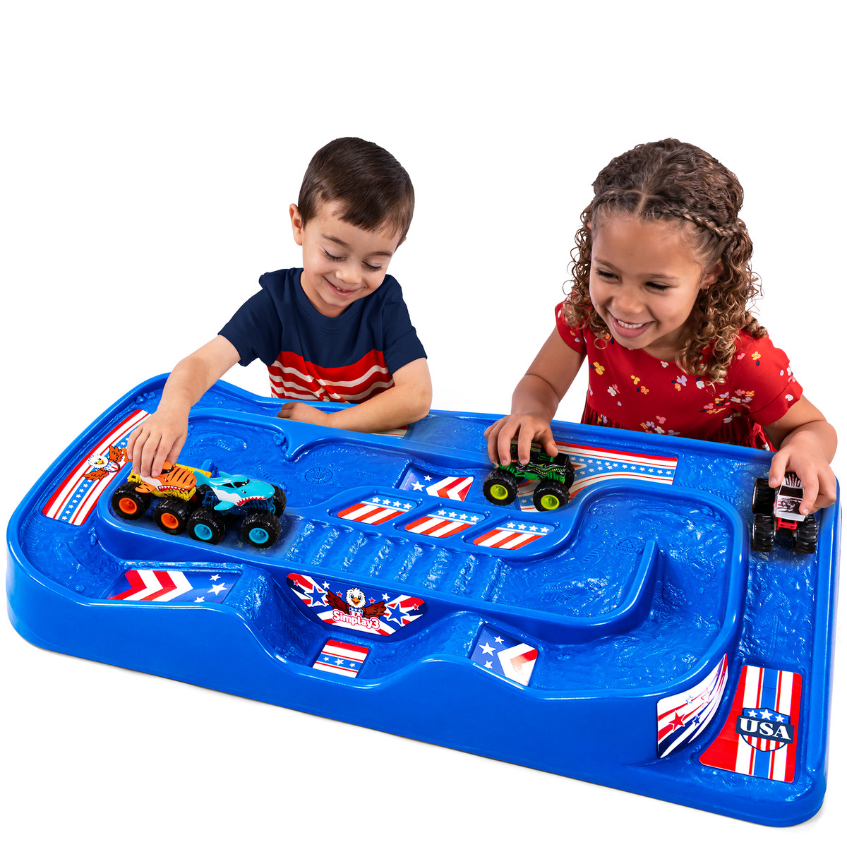 Boy and girl racing cars and trucks on the simplay3 carry and go train and track table