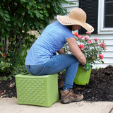 Woman using multi-level Handy Home Seat to garden