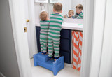 Two children brushing teeth and standing on a Periwinkle Sibling Step Stool