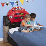 Boys reading on a twin mattress attached to the Monster Truck Headboard