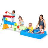 Many children playing around the Simplay3 Raindrop Falls Water Table Splash Pool using the included water play accessories