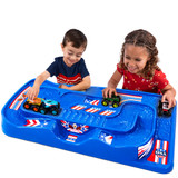 Boy and girl racing cars and trucks on the simplay3 carry and go train and track table