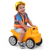 toddler boy riding yellow Simplay3 Rugged Rider Dump Truck in construction costume