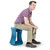 Young man sitting on active balance stool