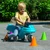 Toddler boy maneuvering through colorful cones in the driveway
