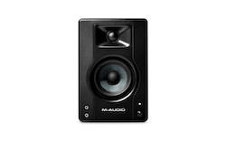 M-Audio BX3 Graphite 3.5" Powered Studio Monitor — 3.5-inch carbon fiber woofer, 1-inch silk dome tweeter, 20W total output (10W per channel), rear bass reflex port, front 1/8" AUX and headphone inputs, rear RCA and 1/4"/1/8" inputs, MDF vinyl-wrapped cabinet for professional studio recording and multimedia use