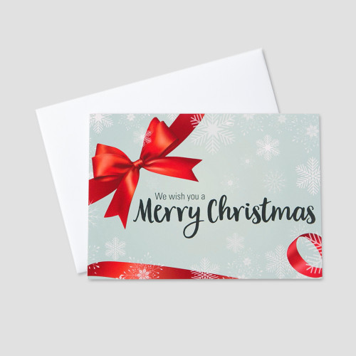 Corporate Christmas greeting card with a Christmas message surrounded by falling snowflakes and red bow