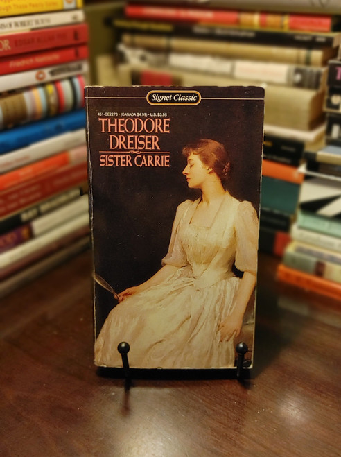 Sister Carrie by Theodore Dreiser is a powerful exploration of ambition, desire, and the relentless pursuit of happiness. Set in the late 19th century, the novel follows the life of Carrie Meeber, a young woman who leaves her small-town life in search of success and love in Chicago. As Carrie encounters the seductions of city life, including a series of influential relationships and opportunities, she struggles with the consequences of her choices and the harsh realities of societal expectations. Dreiser’s vivid portrayal of Carrie’s rise and fall, combined with his naturalistic writing style, makes Sister Carrie a compelling and thought-provoking read that examines the complex interplay between individual aspirations and societal pressures.
About the Author
Theodore Dreiser (1871-1945) was an influential American novelist and journalist best known for his works that explore the harsh realities of American life. Born in Terre Haute, Indiana, Dreiser's early life was marked by poverty and hardship, experiences that deeply informed his literary work. His most famous novels, including Sister Carrie and An American Tragedy, are renowned for their naturalistic approach and critical portrayal of social and economic forces. Dreiser's writing is celebrated for its unflinching realism and psychological depth, making him a pivotal figure in American literary history and a key contributor to the naturalist movement.
This is one of the many featured books in my Whatnot Live Buy-it-Now auction. However, if you purchase the book directly on my store website, you will receive one dollar off by entering the coupon code TAKE1OFF. Sister Carrie by Theodore Dreiser is a powerful exploration of ambition, desire, and the relentless pursuit of happiness. Set in the late 19th century, the novel follows the life of Carrie Meeber, a young woman who leaves her small-town life in search of success and love in Chicago. As Carrie encounters the seductions of city life, including a series of influential relationships and opportunities, she struggles with the consequences of her choices and the harsh realities of societal expectations. Dreiser’s vivid portrayal of Carrie’s rise and fall, combined with his naturalistic writing style, makes Sister Carrie a compelling and thought-provoking read that examines the complex interplay between individual aspirations and societal pressures.
About the Author
Theodore Dreiser (1871-1945) was an influential American novelist and journalist best known for his works that explore the harsh realities of American life. Born in Terre Haute, Indiana, Dreiser's early life was marked by poverty and hardship, experiences that deeply informed his literary work. His most famous novels, including Sister Carrie and An American Tragedy, are renowned for their naturalistic approach and critical portrayal of social and economic forces. Dreiser's writing is celebrated for its unflinching realism and psychological depth, making him a pivotal figure in American literary history and a key contributor to the naturalist movement.
This is one of the many featured books in my Whatnot Live Buy-it-Now auction. However, if you purchase the book directly on my store website, you will receive one dollar off by entering the coupon code TAKE1OFF.