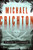 From one of the best-loved authors of all time comes an irresistible adventure of swashbuckling pirates in the New World, a classic story of treasure and betrayal.
The Caribbean, 1665. A remote colony of the English Crown, the island of Jamaica holds out against the vast supremacy of the Spanish empire. Port Royal, its capital, is a cutthroat town of taverns, grog shops, and bawdy houses. 
In this steamy climate there's a living to be made, a living that can end swiftly by disease—or by dagger. For Captain Charles Hunter, gold in Spanish hands is gold for the taking, and the law of the land rests with those ruthless enough to make it. 
Word in port is that the galleon El Trinidad, fresh from New Spain, is awaiting repairs in a nearby harbor. Heavily fortified, the impregnable harbor is guarded by the bloodthirsty Cazalla, a favorite commander of the Spanish king himself. With backing from a powerful ally, Hunter assembles a crew of ruffians to infiltrate the enemy outpost and commandeer El Trinidad, along with its fortune in Spanish gold. The raid is as perilous as the bloodiest tales of island legend, and Hunter will lose more than one man before he even sets foot on foreign shores, where dense jungle and the firepower of Spanish infantry stand between him and the treasure. . . .
Pirate Latitudes is Michael Crichton at his best: a rollicking adventure tale pulsing with relentless action, crackling atmosphere, and heart-pounding suspense. From one of the best-loved authors of all time comes an irresistible adventure of swashbuckling pirates in the New World, a classic story of treasure and betrayal.
The Caribbean, 1665. A remote colony of the English Crown, the island of Jamaica holds out against the vast supremacy of the Spanish empire. Port Royal, its capital, is a cutthroat town of taverns, grog shops, and bawdy houses. 
In this steamy climate there's a living to be made, a living that can end swiftly by disease—or by dagger. For Captain Charles Hunter, gold in Spanish hands is gold for the taking, and the law of the land rests with those ruthless enough to make it. 
Word in port is that the galleon El Trinidad, fresh from New Spain, is awaiting repairs in a nearby harbor. Heavily fortified, the impregnable harbor is guarded by the bloodthirsty Cazalla, a favorite commander of the Spanish king himself. With backing from a powerful ally, Hunter assembles a crew of ruffians to infiltrate the enemy outpost and commandeer El Trinidad, along with its fortune in Spanish gold. The raid is as perilous as the bloodiest tales of island legend, and Hunter will lose more than one man before he even sets foot on foreign shores, where dense jungle and the firepower of Spanish infantry stand between him and the treasure. . . .
Pirate Latitudes is Michael Crichton at his best: a rollicking adventure tale pulsing with relentless action, crackling atmosphere, and heart-pounding suspense.