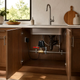 Smart water valve controller installed beneath a kitchen sink on a compatible water supply line, providing remote shut-off capability and smart home leak protection.
