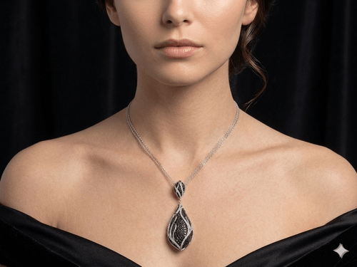 Model wearing teardrop pendant with black and white diamonds and gray dress.