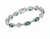 ​Green chrome diopside gemstone bracelet displayed on cushion