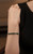 Green peridot gemstone bracelet displayed on cushion