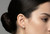 CZ star drop chain earrings displayed on cushion model ear