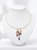 close up front view of 14K gold necklace with cascading amethyst gemstones