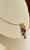 side view of 14K gold necklace with cascading amethyst gemstones