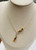 side angle of artistic 14K gold necklace with cirtine ,garnet and diamond gemstones