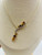 close-up of natural cirtine ,garnet and diamond gemstones drop in gold necklace