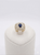 Side view of wide gold cocktail ring showing channel-set baguette diamonds and pavé rows.