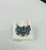 Macro close-up shot of Ceylon blue sapphires and 0.39 ctw diamond halos on an EFFY white gold ring.