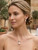model wearing Side profile detail shot of EFFY 14k white gold pearl and diamond post earrings showing the secure setting.