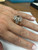 modeling A refined model's hand wearing a wide, luxury two-tone statement ring on the ring finger, featuring alternating layers of high-polish yellow gold and brilliant diamond pavé-set bands on a clean background.