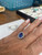 shown on models hand A horizontal shot featuring the ring styled naturally in a high-end, softly lit setting—perfect for an elegant website banner, collection cover, or digital lookbook asset.