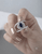 Close-up of EFFY 1.42 CT oval blue sapphire and diamond statement ring held in hand.
