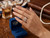 Close up side angle of EFFY 3.77 DWT two tone gold multi band diamond statement ring against white studio background.