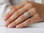 EFFY emerald-cut diamond engagement ring with rose gold halo worn on a model’s finger