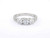 EFFY three-stone diamond ring held between a model’s fingers showing the center and side diamonds