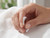 EFFY 14K white gold three-stone diamond ring held by a model