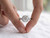 EFFY round diamond halo engagement ring held between a model’s fingers showing the twist pavé shank