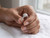 EFFY round diamond halo engagement ring held on a model’s hand