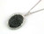 Front view of EFFY 14K white gold oval black and white diamond halo pendant