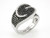 Close-up of EFFY black and white diamond ring showing the pavé swirl design