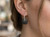Close-up of EFFY 14K white gold black and white diamond earrings worn by a model.