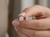 Close-up of EFFY 0.98 CTW white diamond stud earring held in hand
