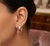 Elegant model wearing EFFY 14K yellow gold multi-color sapphire and diamond statement earrings
