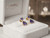EFFY 14K yellow gold tanzanite and diamond earrings displayed inside a luxury EFFY-branded white velvet presentation box