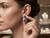 Elegant model wearing EFFY 14K yellow gold tanzanite and diamond statement earrings