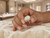 Close-up of model holding the EFFY opal ring between two fingers