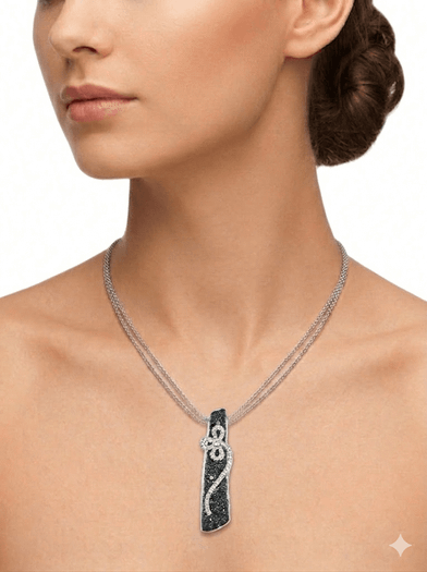 14K white gold Vertical black diamond bar pendant with white diamond floral vine on a white background.
