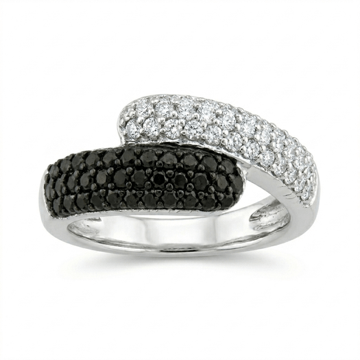 Elegant flat lay of a black and white diamond statement ring showing the bypass transition and high-gloss finish.