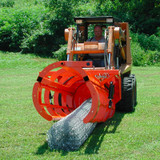 EZ Grout Fence Hog Skid Steer Attachment picking up fence material