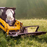 Severe Duty Bent Axis Brush Cutter on skid steer, in use.