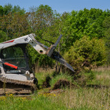 CID Skid Steer Tree Terminator Attached Tilted Down Pulling Tree