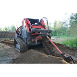 The Eterra 48" Skid Steer Trencher attached digging