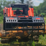 Surge Grapple rake picking up a log using kubota skid steer